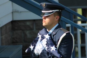 Man in uniform holding flag
